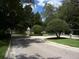 Paver driveway leads to a landscaped entrance with manicured shrubbery and decorative street lamps at 586 Brantley Terrace Way # 201, Altamonte Springs, FL 32714