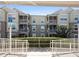 Condo building featuring screened patios, white railings, and manicured shrubbery along the front entrance at 586 Brantley Terrace Way # 201, Altamonte Springs, FL 32714