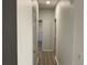 Hallway with wood look floors and white walls with multiple doors at 586 Brantley Terrace Way # 201, Altamonte Springs, FL 32714