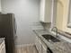 Galley kitchen with granite countertops, stainless steel appliances, and a modern faucet at 586 Brantley Terrace Way # 201, Altamonte Springs, FL 32714