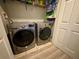Laundry area with modern front-loading washer and dryer, plus overhead storage at 586 Brantley Terrace Way # 201, Altamonte Springs, FL 32714