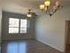 Well-lit living room with laminate flooring, a ceiling fan, and a large window for natural light at 586 Brantley Terrace Way # 201, Altamonte Springs, FL 32714