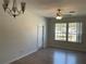 Well-lit living room with laminate flooring, a ceiling fan, and a large window for natural light at 586 Brantley Terrace Way # 201, Altamonte Springs, FL 32714
