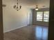 Inviting living room with wood-look floors, ceiling fan, chandelier, and lots of light at 586 Brantley Terrace Way # 201, Altamonte Springs, FL 32714