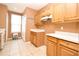 Clean kitchen featuring wooden cabinets and a window view at 660 Captiva Cir, Kissimmee, FL 34741