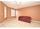 Bright living room featuring a ceiling fan and large windows at 660 Captiva Cir, Kissimmee, FL 34741