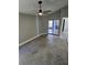 Neutral bedroom with ceiling fan, tile flooring, and a sliding glass door to the screened porch at 703 Pine Shores Cir, New Smyrna Beach, FL 32168