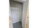 Empty closet with white walls, doors, a single wire shelf and gray carpet at 703 Pine Shores Cir, New Smyrna Beach, FL 32168