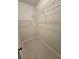 Walk-in closet with wire shelving and tile flooring at 703 Pine Shores Cir, New Smyrna Beach, FL 32168