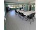 Community room featuring tables, chairs, and ample space for activities at 703 Pine Shores Cir, New Smyrna Beach, FL 32168