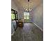A empty dining area with chandelier-style light fixture and sliding glass door to the backyard at 703 Pine Shores Cir, New Smyrna Beach, FL 32168