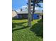 Blue home exterior with green lawn, mature trees and an enclosed patio at 703 Pine Shores Cir, New Smyrna Beach, FL 32168