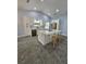 Kitchen features white cabinets, stainless appliances, island with breakfast bar, and pendant lights at 703 Pine Shores Cir, New Smyrna Beach, FL 32168