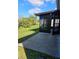 Enclosed patio with a view of the landscaped backyard and adjacent pond at 703 Pine Shores Cir, New Smyrna Beach, FL 32168