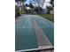 Outdoor shuffleboard court with benches nearby for players and spectators at 703 Pine Shores Cir, New Smyrna Beach, FL 32168