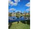 Scenic water view with a reflection of houses on the lake and a clear blue sky at 703 Pine Shores Cir, New Smyrna Beach, FL 32168