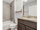 Modern bathroom featuring granite countertops, tiled shower, and wooden vanity at 7139 Se 122Nd Ln, Belleview, FL 34420