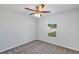 Bedroom with a ceiling fan, gray carpet, and a window providing natural light at 7139 Se 122Nd Ln, Belleview, FL 34420
