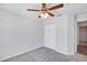 Bedroom featuring gray carpet, closet, ceiling fan and a door that leads to another room at 7139 Se 122Nd Ln, Belleview, FL 34420