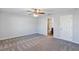 Spacious bedroom featuring plush carpeting, ceiling fan, and access to a private ensuite bathroom at 7139 Se 122Nd Ln, Belleview, FL 34420