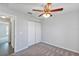 Cozy bedroom with neutral carpet, ceiling fan, and double door closet at 7139 Se 122Nd Ln, Belleview, FL 34420