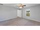 Bedroom featuring gray carpet, a ceiling fan, and a window providing natural light at 7139 Se 122Nd Ln, Belleview, FL 34420