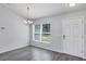 Bright dining room with modern chandelier, neutral walls, and wood-look floors at 7139 Se 122Nd Ln, Belleview, FL 34420