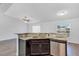 Kitchen island featuring a granite countertop, sink, dishwasher, and dark wood cabinetry at 7139 Se 122Nd Ln, Belleview, FL 34420