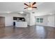 Open-concept living room with kitchen, dining area, and stylish gray flooring at 7139 Se 122Nd Ln, Belleview, FL 34420