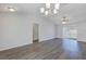 Bright living room with modern ceiling fan, neutral walls, and wood-look floors at 7139 Se 122Nd Ln, Belleview, FL 34420