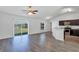 Bright living room flows into the kitchen, featuring wood-look floors, neutral walls, and modern appliances at 7139 Se 122Nd Ln, Belleview, FL 34420