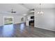 Open-concept living room featuring wood-look floors, vaulted ceilings, and a seamless transition into the kitchen at 7139 Se 122Nd Ln, Belleview, FL 34420