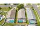 Aerial view of homes featuring screened-in pools and well-maintained yards in a quiet neighborhood at 8095 Indian Creek Blvd, Kissimmee, FL 34747