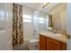 Bathroom with a shower-tub combination, neutral walls, and a vanity with sink at 8095 Indian Creek Blvd, Kissimmee, FL 34747
