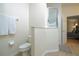Bathroom featuring a toilet, shower, and doorway leading to the bedroom at 8095 Indian Creek Blvd, Kissimmee, FL 34747