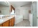 Bathroom featuring double sinks, a tub, and a walk-in shower, creating a spa-like experience at 8095 Indian Creek Blvd, Kissimmee, FL 34747