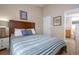 Cozy bedroom showcases a bed, side table with lamp, and ensuite bathroom entrance at 8095 Indian Creek Blvd, Kissimmee, FL 34747