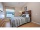 Comfortable bedroom features a queen bed, neutral decor, and a window with natural light at 8095 Indian Creek Blvd, Kissimmee, FL 34747