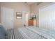 Well-lit bedroom with TV, closet, and doorway to ensuite bathroom at 8095 Indian Creek Blvd, Kissimmee, FL 34747