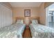 Bedroom featuring two twin beds, a window, and a closet, offering ample storage at 8095 Indian Creek Blvd, Kissimmee, FL 34747
