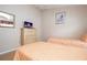 Bedroom with two twin beds, light wood floors, a TV on dresser, and lots of light at 8095 Indian Creek Blvd, Kissimmee, FL 34747