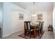 Cozy dining room with a chandelier, marble-topped table, and arched doorway at 8095 Indian Creek Blvd, Kissimmee, FL 34747