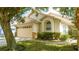 Charming single Gathering home featuring an attached two-car garage and well maintained landscaping at 8095 Indian Creek Blvd, Kissimmee, FL 34747