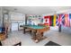 Finished garage with a pool table, washer, dryer, and flags at 8095 Indian Creek Blvd, Kissimmee, FL 34747