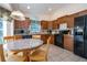 Charming eat-in kitchen features tile flooring, black appliances, and abundant natural light at 8095 Indian Creek Blvd, Kissimmee, FL 34747