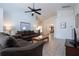 Warm living room with ample seating, tile flooring, and views into the dining room at 8095 Indian Creek Blvd, Kissimmee, FL 34747