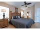 Main bedroom featuring a king bed, ceiling fan, and en-suite bathroom, designed for relaxation at 8095 Indian Creek Blvd, Kissimmee, FL 34747