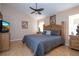 Comfortable main bedroom featuring a large bed, ceiling fan, and warm, inviting decor at 8095 Indian Creek Blvd, Kissimmee, FL 34747