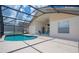 Backyard oasis features a screened-in pool and patio area, perfect for outdoor enjoyment at 8095 Indian Creek Blvd, Kissimmee, FL 34747
