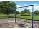 Community playground featuring three blue swings in a common area at 8095 Indian Creek Blvd, Kissimmee, FL 34747